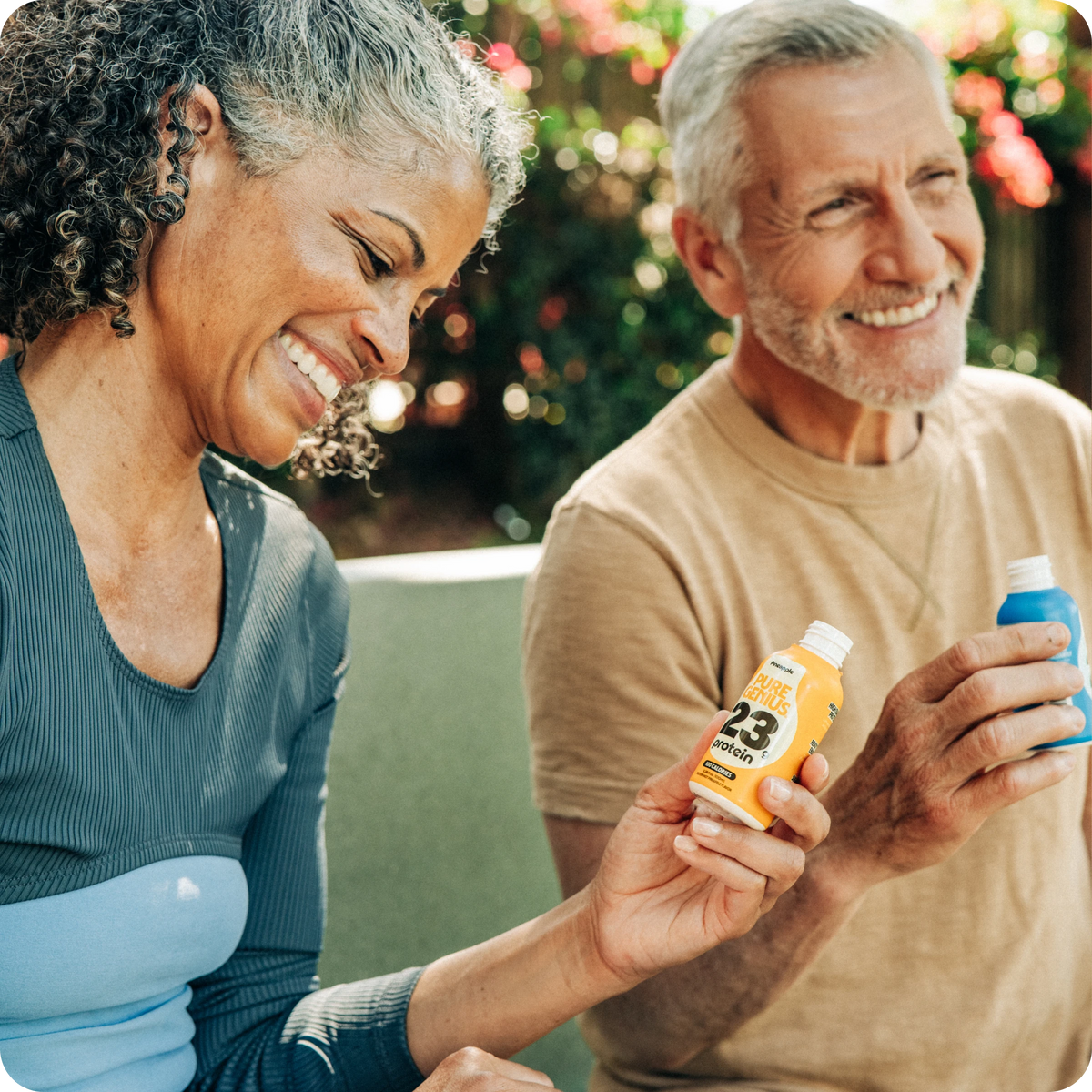 Couple holding Pure Genius protein shots